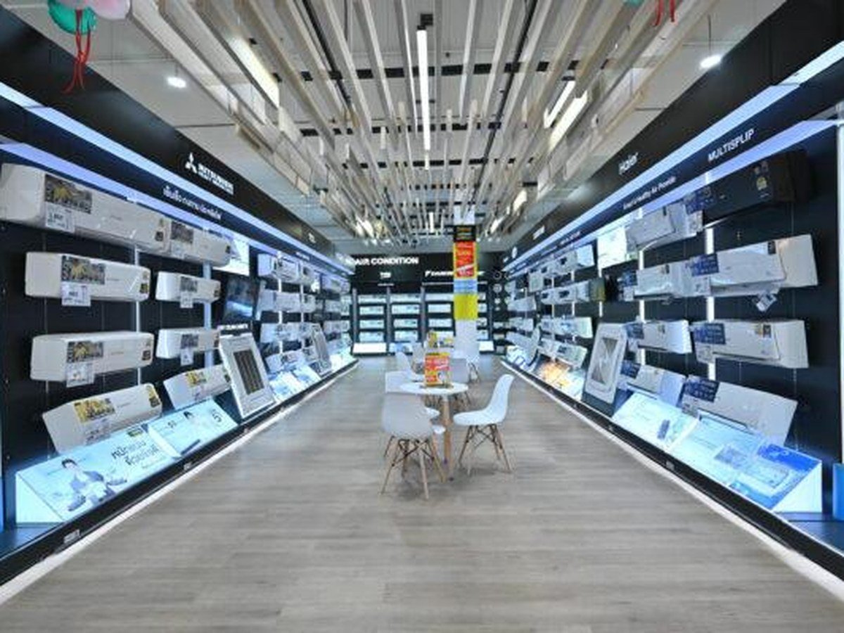 Full aisle of wall-mounted air conditioner displays in a showroom