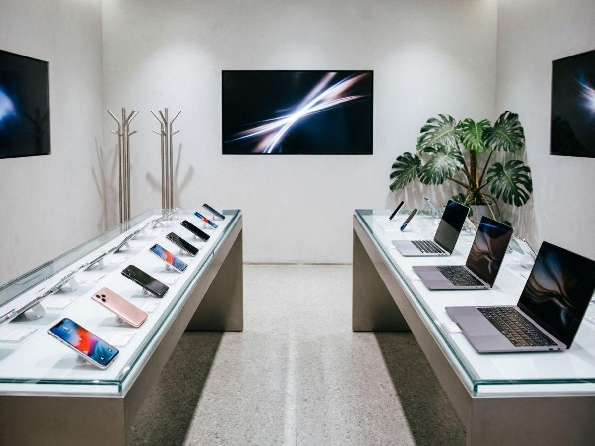 Glass display cases showcasing phones and laptops